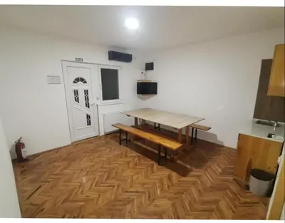 a room with a wooden table and a wooden floor at V U Sobe in Brzi Brod