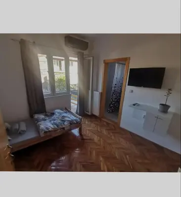 a room with a bed and a television in a room at V U Sobe in Brzi Brod