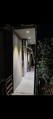 a hallway leading to a building at night at V U Sobe in Brzi Brod