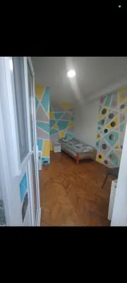 a room with a bed and a wooden floor at V U Sobe in Brzi Brod