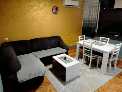 a living room with a couch and a table at Apartman Zdravković in Leskovac