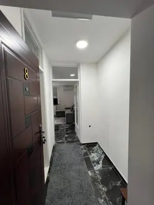 a hallway with a door and a tile floor at Apartman Boža 1 in Kuršumlija