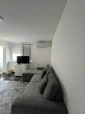 a living room with a couch and a television at Apartman Boža 1 in Kuršumlija