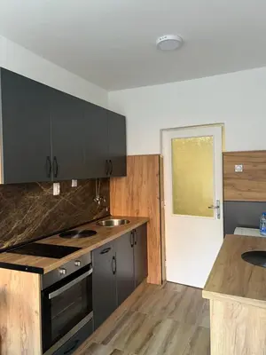 a kitchen with gray cabinets and a counter top at Apartman Boža 2 in Kuršumlija