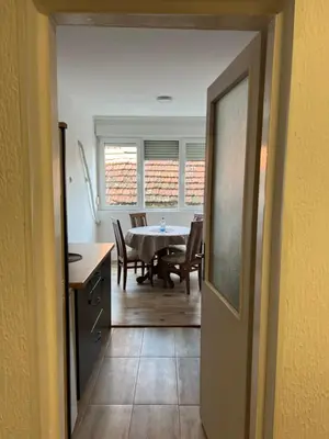 a kitchen and dining room with a table and chairs at Apartman Boža 2 in Kuršumlija