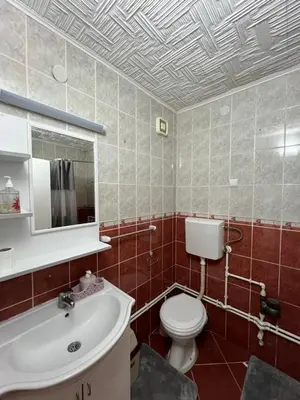 a bathroom with a toilet and a sink at Apartman Boža 2 in Kuršumlija