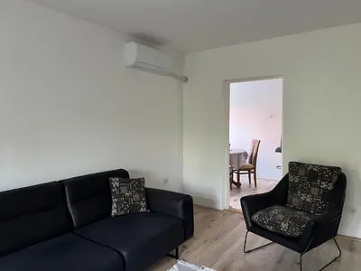 a living room with a couch and a chair at Apartman Boža 2 in Kuršumlija