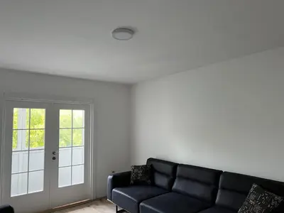a living room with a couch and a window at Apartman Boža 2 in Kuršumlija
