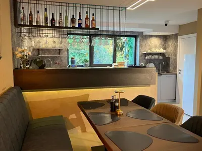 a kitchen with a table and some bottles on the wall at Vila Pozitiv in Sisevac