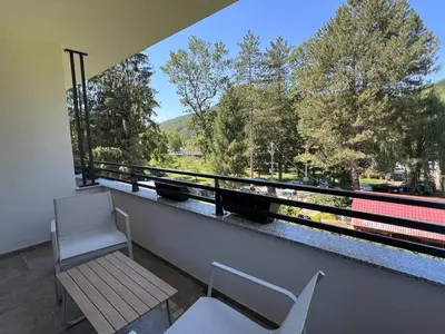a balcony with a bench and a window with a view at Vila Pozitiv in Sisevac