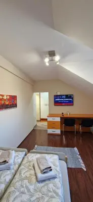 an attic room with two beds and a desk at PlavDom2 in Ćuprija