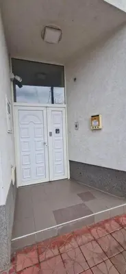 a white door in a room with a wall at PlavDom2 in Ćuprija