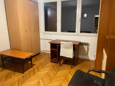 a room with a desk and a chair and a table at Neda in Niš