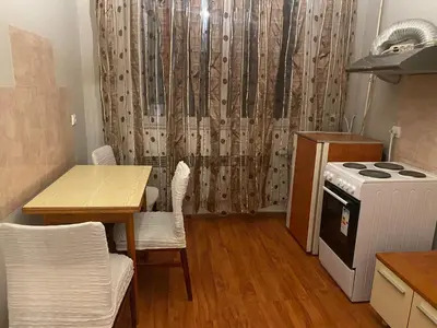 a small kitchen with a table and a stove at Neda in Niš