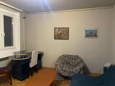 a living room with a table and a chair at Neda in Niš