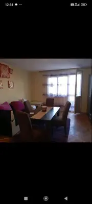a living room with a dining room table and chairs at Apartman Krstic in Jagodina