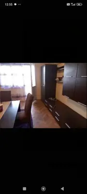 a living room with a dining table and a kitchen at Apartman Krstic in Jagodina