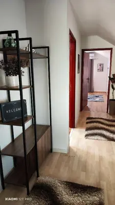 a room with a shelf with a mirror and a hallway at JetNest in Niš