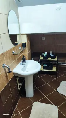 a bathroom with a white sink and a mirror at JetNest in Niš
