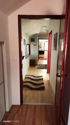 a hallway with a door open to a living room at JetNest in Niš