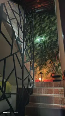 a staircase with a mural of a palm tree at JetNest in Niš