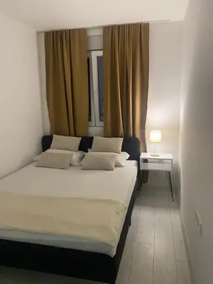 a bedroom with a large bed with two pillows at Day and night in Prokuplje