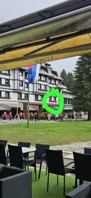 a group of chairs and tables in front of a building at APEX Konaci Koznik in Kopaonik