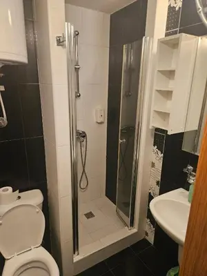 a bathroom with a shower and a toilet and a sink at APEX Konaci Koznik in Kopaonik