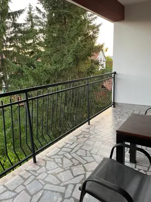 a balcony with a table and chairs and a fence at Travel Rest in Bujanovac