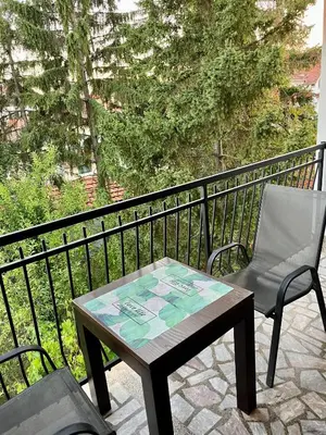 a table and a chair on a balcony at Travel Rest in Bujanovac