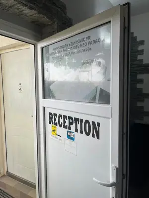 a door with a evacuation sign on it at Prenociste H2O in Paraćin