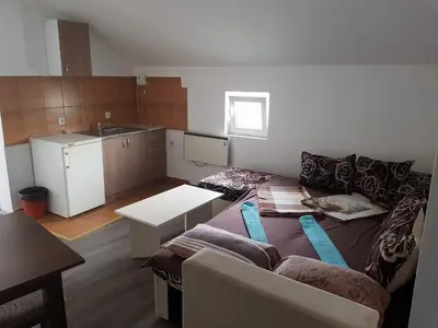 a living room with a couch and a table at Prenociste H2O in Paraćin
