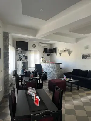 a living room with a couch and a table and chairs at Prenociste H2O in Paraćin