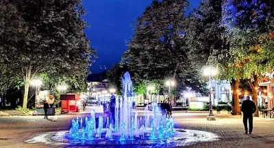 a fountain in the middle of a street at night at Paradise in Lipova in Vrnjačka Banja