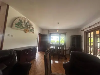 a living room with a table and a dining room at Paradise in Lipova in Vrnjačka Banja