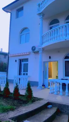 a white house with a porch and a balcony at Clementine in Soko Banja
