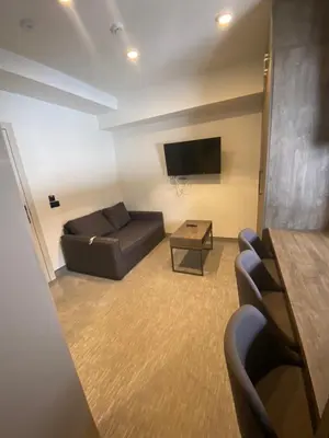 a waiting room with a couch and a tv at Apartmani Vrh Konaci in Kopaonik