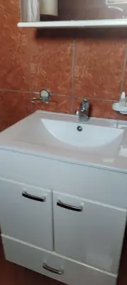 a white bathroom sink with a mirror above it at Stamenković in Vranje