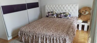 a bedroom with a bed and a teddy bear at Stamenković in Vranje