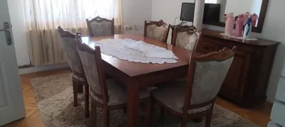 a dining room table with four chairs and a mirror at Stamenković in Vranje