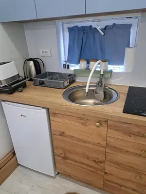 a kitchen counter with a sink and a window at Apartman Viktorija in Jošanička Banja