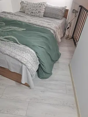 a bedroom with a bed and a tiled floor at Apartman Viktorija in Jošanička Banja