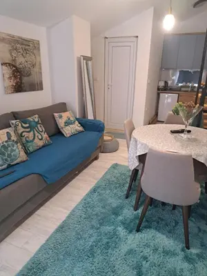 a living room with a couch and a table at Apartman Viktorija in Jošanička Banja