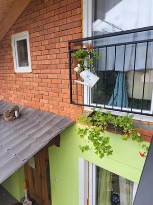 a balcony with plants on the side of a building at Apartman Viktorija in Jošanička Banja