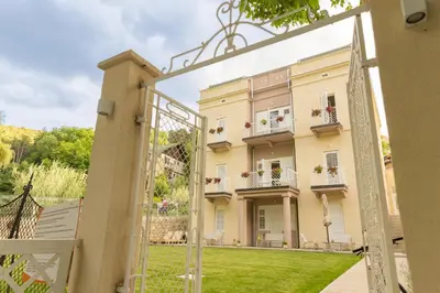 a view through an open gate to a building at Vila Nada Sokobanja in Soko Banja