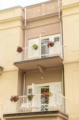 a building with two balconies with flowers on them at Vila Nada Sokobanja in Soko Banja
