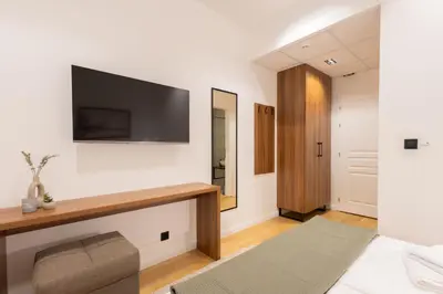 a living room with a television on a wall at Vila Nada Sokobanja in Soko Banja