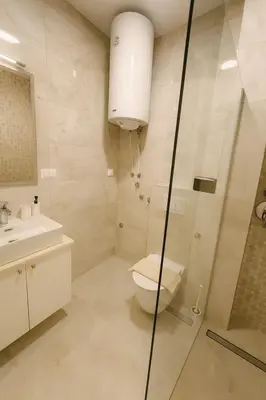 a bathroom with a toilet and a glass shower at Luxury Stay in Vrnjačka Banja C2 in Vrnjačka Banja