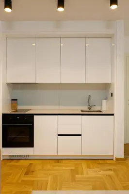 a kitchen with white cabinets and a sink at Luxury Stay in Vrnjačka Banja C2 in Vrnjačka Banja