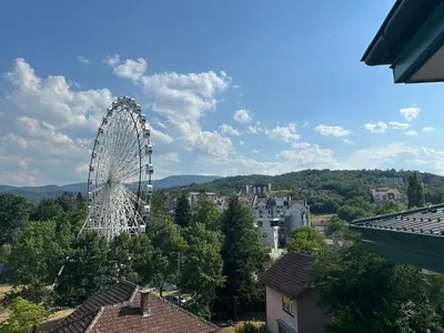 a ferris wheel in the middle of a city at Luxury Stay in Vrnjačka Banja C2 in Vrnjačka Banja